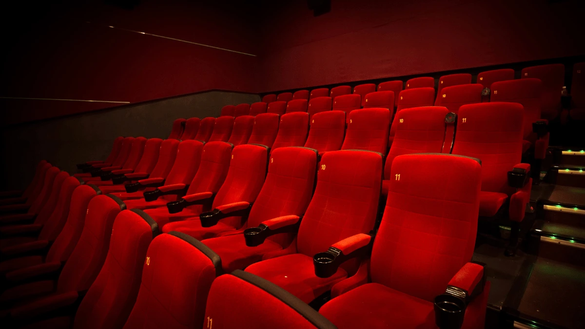 a row of red seats in a movie theater