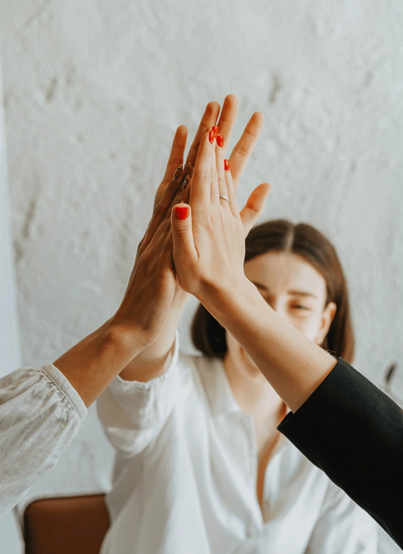 An image of people supporting each other, touching hands. Support for carers.
